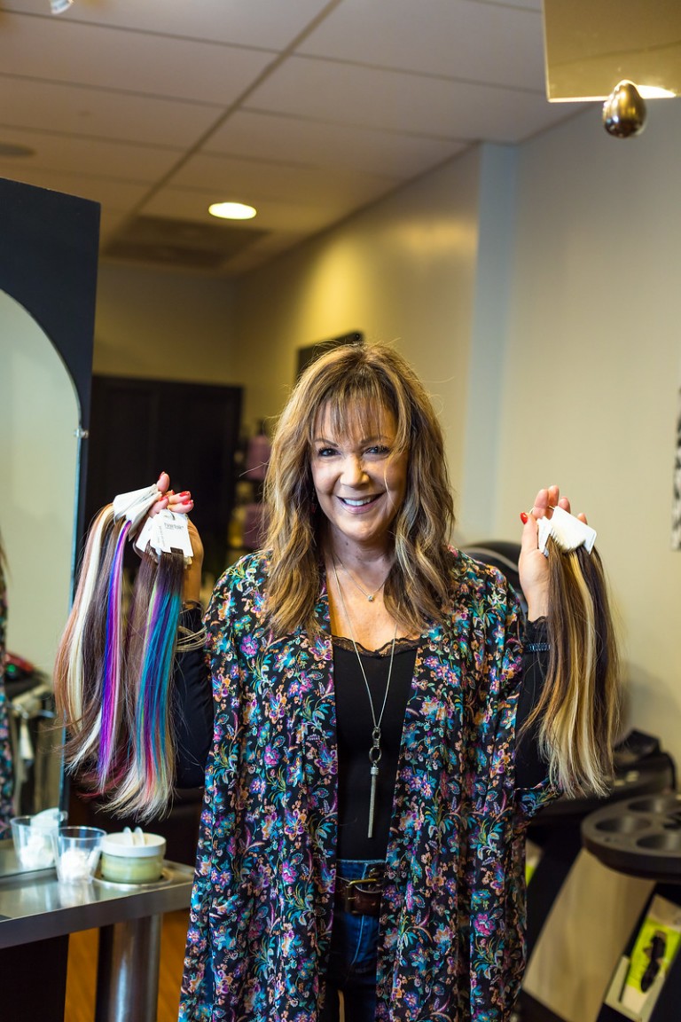 Stylist holding hair extension color samples